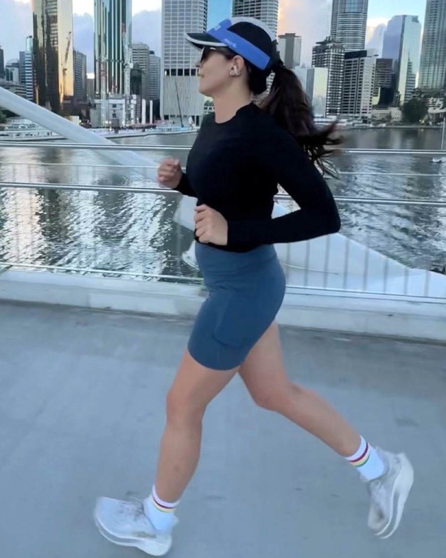 Jacinta running across a Brisbane bridge